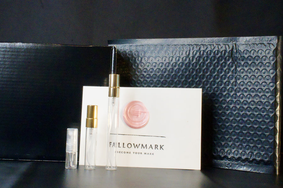 Everything in a Fallowmark order: three glass vials, the card with a pink wax seal, the black box and the black bubble mailer